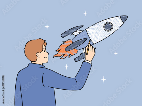Businessman draws space rocket symbolizing successful launches and business ambitions or striving to achieve goals. Concept of starting and developing your own business or looking for investments