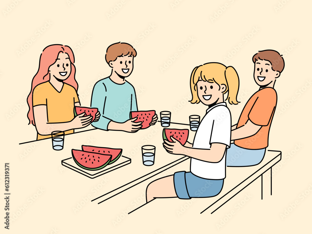 Children eat watermelon sitting at table and enjoying sweet refreshing dessert on hot summer day. Childrens picnic for boys and girls with delicious watermelon containing healthy vitamins Children eat watermelon sitting at table and enjoying sweet refreshing dessert on hot summer day. Childrens picnic for boys and girls with delicious watermelon containing healthy vitamins