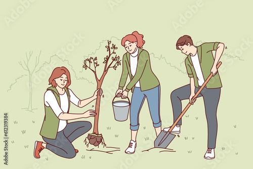 Volunteers plant trees in park and water seedlings to save nature from co2 emissions and climate change. People with paw and bucket for planting trees helping ecology recover after deforestation