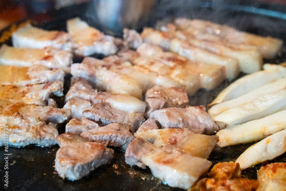 Fresh and delicious iron pan-fried black pork meal in Jeju Korean restaurant. Fresh and delicious iron pan-fried black pork meal in Jeju Korean restaurant.