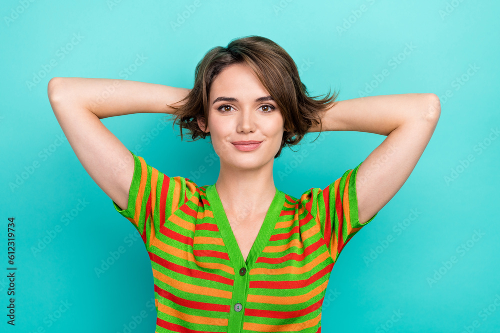 Portrait of nice satisfied glad lady arms behind head enjoy free time isolated on turquoise color background