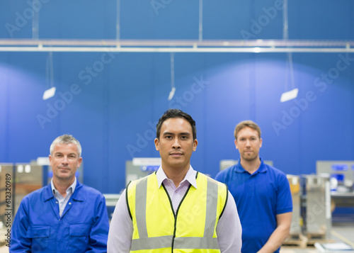 Portrait confident manager and workers in steel factory