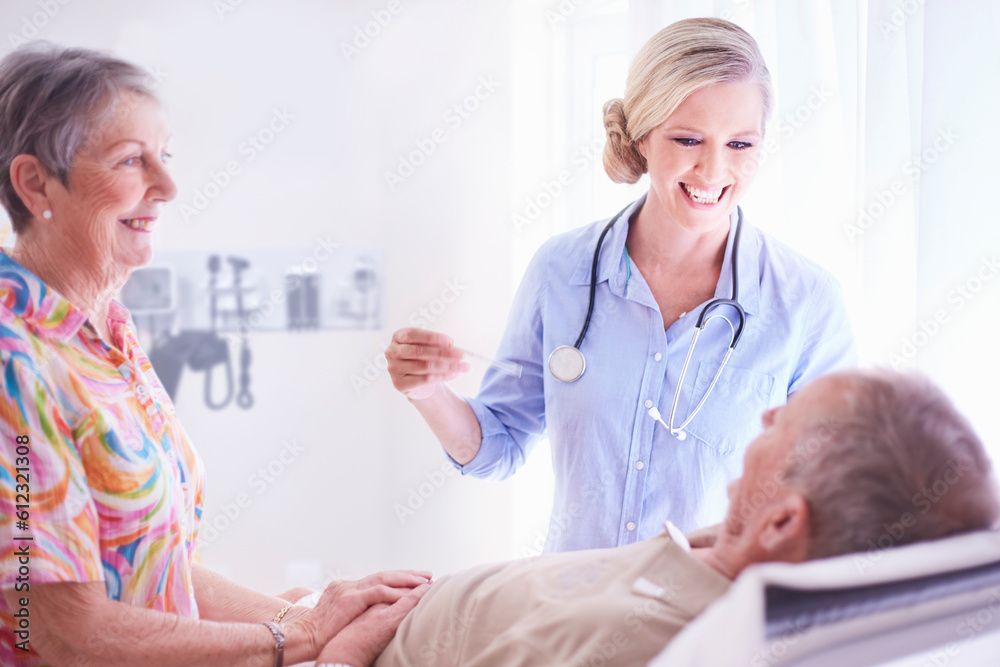 Smiling doctor checking senior man’s temperature Smiling doctor checking senior man’s temperature