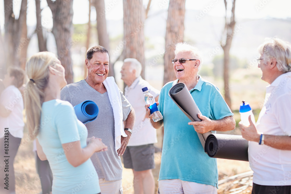 Naklejka premium Yoga instructor talking to senior men after class in park