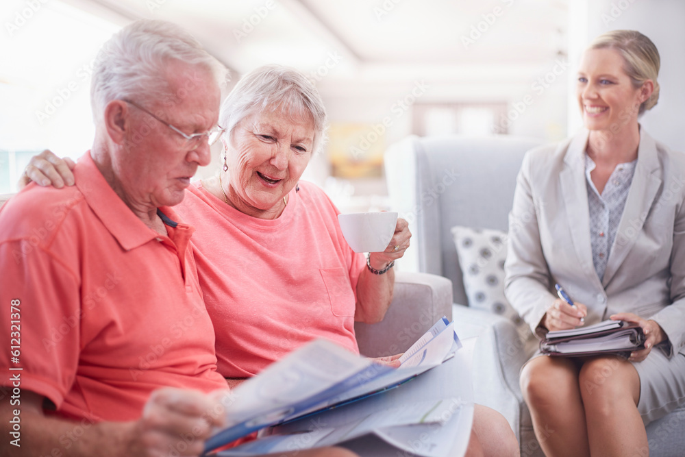 Financial advisor discussing paperwork with senior couple Financial advisor discussing paperwork with senior couple