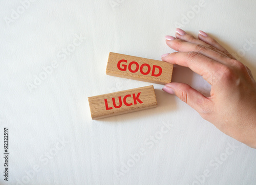 Good luck symbol. Wooden blocks with words Good luck. Businessman hand. Beautiful white background. Business and Good luck concept. Copy space.