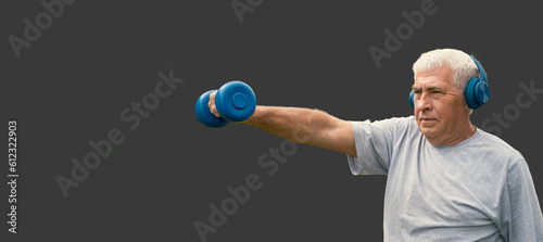 Senior man working out banner. Gray Stusio background. Person lifting dumbbells. Old male exercising. Healthy lifestyle. Active sport training. Older elderly sportsman doing fitness exercise. Workout.