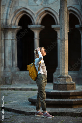 A woman traveler examines an ancient structure.