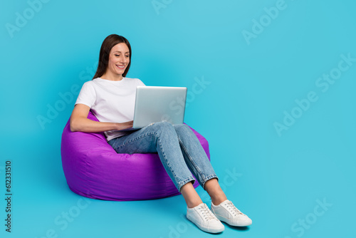 Photo of young girl hold computer smile wear shirt isolated over blue color background