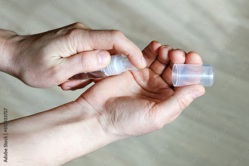 Portable dispenser antiseptic is small, hands are pressed to clean palm of gel