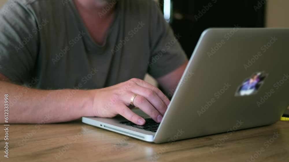 Male hands typing on keyboard laptop lying on wooden table, close-up side view. Integration of technology to increase productivity and work efficiency. Male hands typing on keyboard laptop lying on wooden table, close-up side view. Integration of technology to increase productivity and work efficiency.