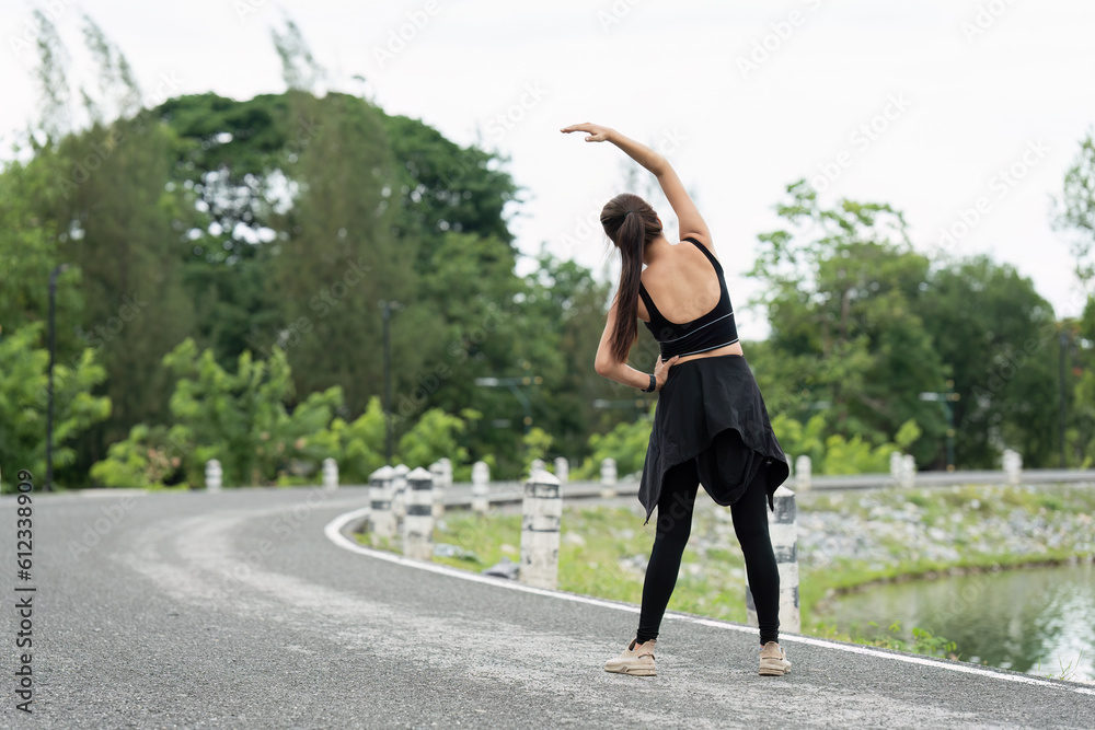 Healthy Asian woman is warm up before jogging outdoor. Fitness girl running. Female exercising at outdoor park Healthy Asian woman is warm up before jogging outdoor. Fitness girl running. Female exercising at outdoor park