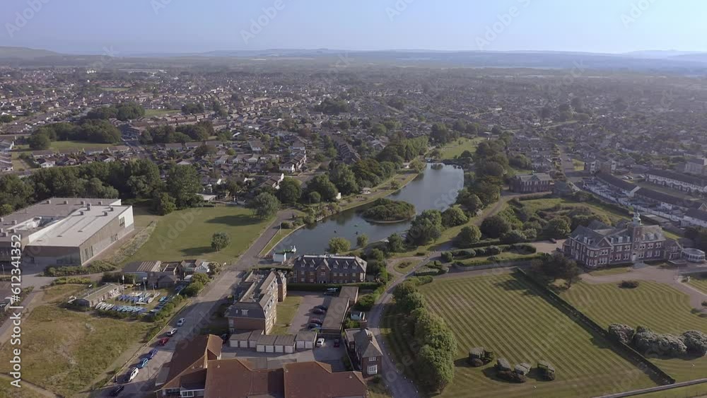 Mewsbrook Park on the border between Littlehampton and Rustington, a popular park with Art Deco shelters and a boating and wildlife lake, aerial footage.