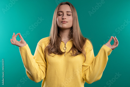 Calm woman relaxing, meditating, refuses stress. Pretty girl breathes deeply