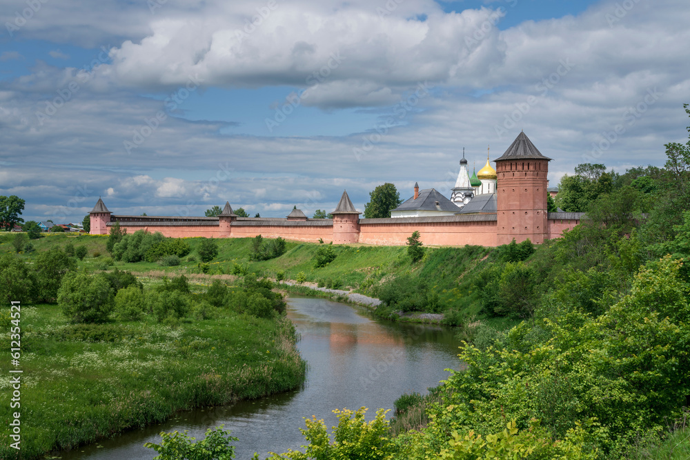 View of the Spaso-Evfimiev Monastery (a monastery of the Vladimir Diocese of the Russian Orthodox Church) on the bank of the Kamenka River on a sunny summer day, Suzdal, Vladimir region, Russia View of the Spaso-Evfimiev Monastery (a monastery of the Vladimir Diocese of the Russian Orthodox Church) on the bank of the Kamenka River on a sunny summer day, Suzdal, Vladimir region, Russia