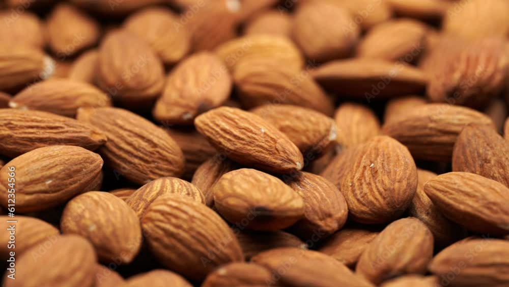 Almond nuts close up rotate in a circle. Nut almond close up. product rich in minerals and vitamins. Almond kernels rotating. A rotating shot of almonds. Texture of Almond kernels. Almond nuts close up rotate in a circle. Nut almond close up. product rich in minerals and vitamins. Almond kernels rotating. A rotating shot of almonds. Texture of Almond kernels.