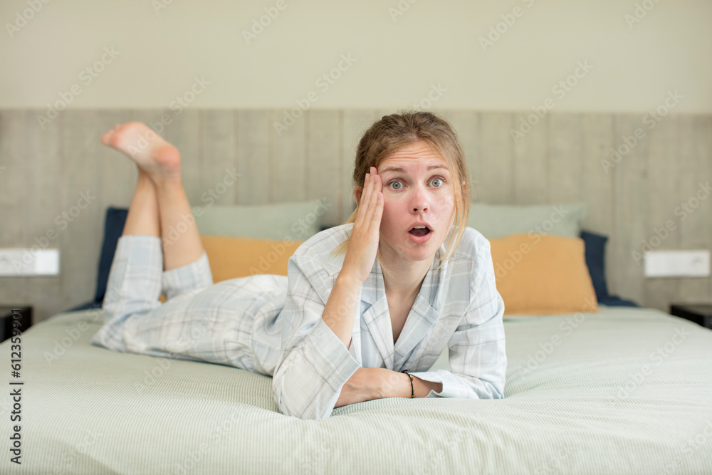 young pretty woman looking happy, astonished and surprised. nightwear concept young pretty woman looking happy, astonished and surprised. nightwear concept