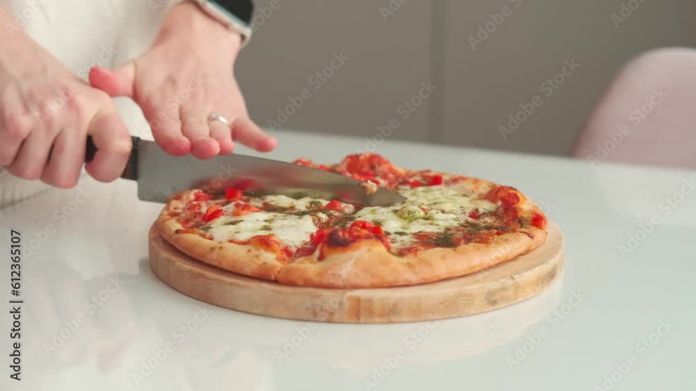 Close up video of woman cutting pizza with knife. Close up video of woman cutting pizza with knife.