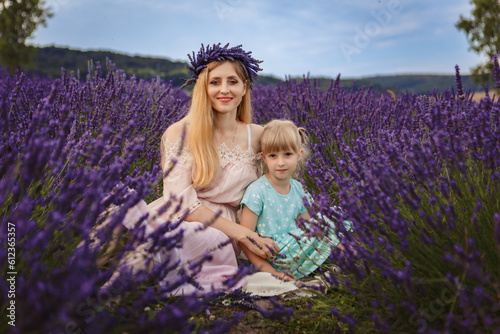 mom hugs her daughter. family picnic on a lavender field