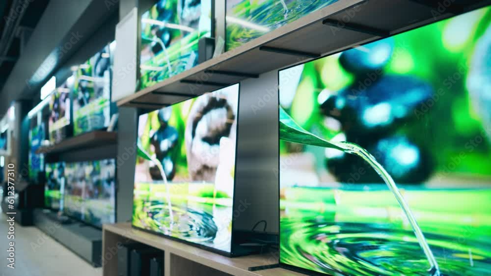 Establishing Shot of Retail Electronics Store Featuring Impressive Wall of TVs with Colorful Macro Demo Footage. Assortment of High-Quality Television Sets in Contemporary Storefront Space