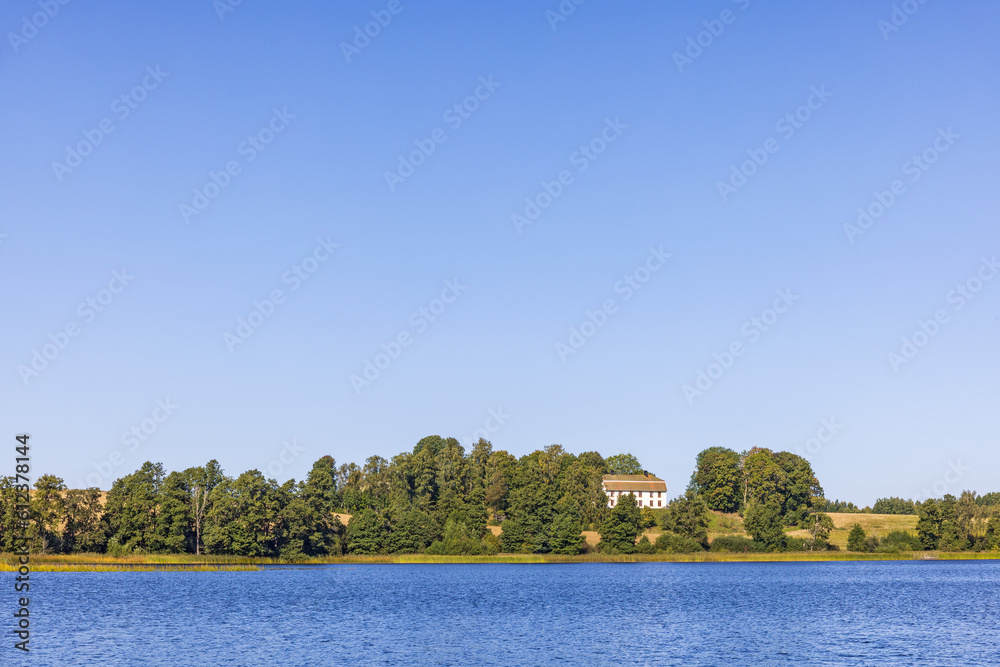 Lake with a manor house on a hill