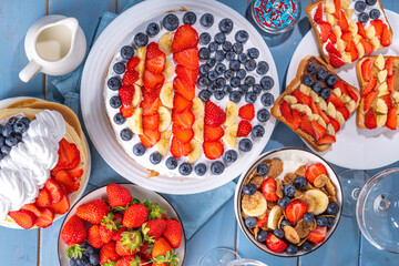 Fourth of July, Patriotic Independence day desserts.  4th of July sweet brunch food and snacks - toast sandwiches, flakes with berries, cake, pancakes, champagne with glasses, holiday decor, flags 