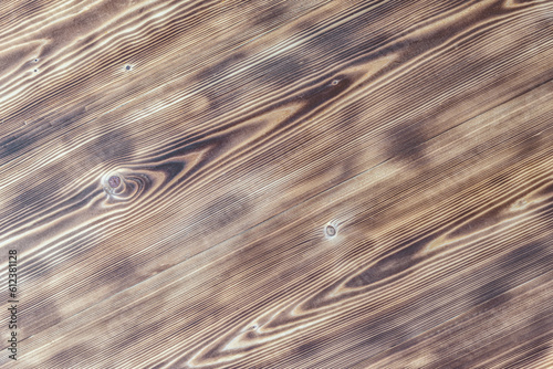 Texture of planed burnt wood as background.