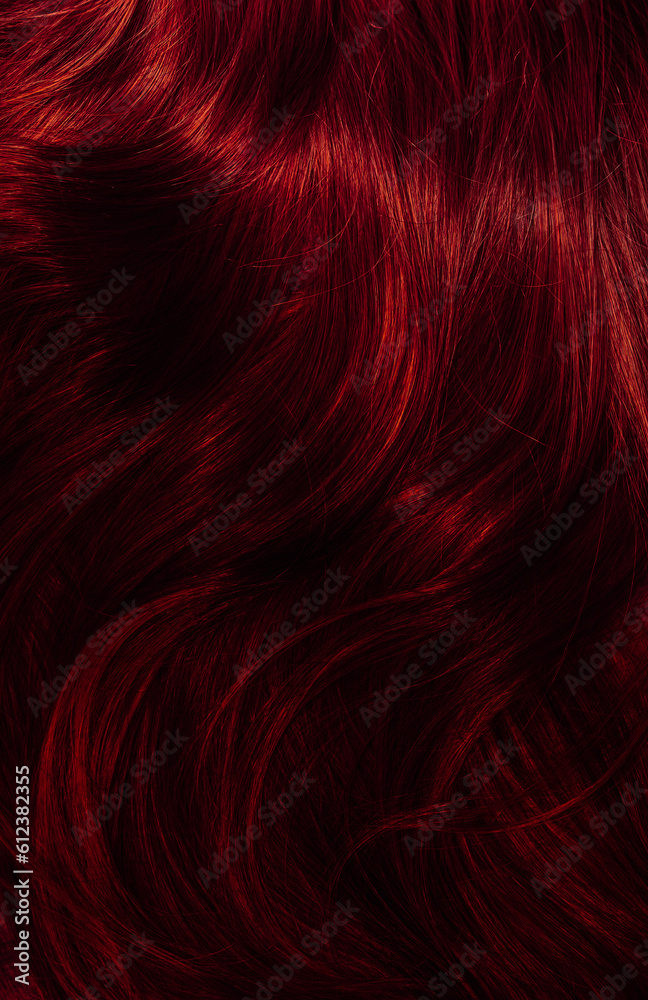 Dark red hair close-up as a background. Women's long brown hair. Beautifully styled wavy shiny curls. Coloring hair with bright shades. Hairdressing procedures, extension. Dark red hair close-up as a background. Women's long brown hair. Beautifully styled wavy shiny curls. Coloring hair with bright shades. Hairdressing procedures, extension.