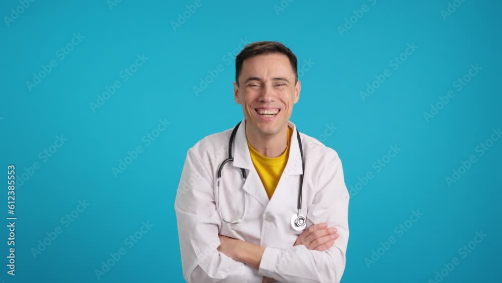 Happy doctor with uniform smiling at camera Happy doctor with uniform smiling at camera