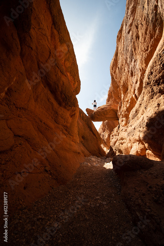 Obraz na płótnie Stunning view of a tourist standing on a rock. Gorges du Dades, Ourzazate. The Dadès Gorges, are a series of rugged wadi gorges carved out by the Dadès River in Morocco. w salonie
