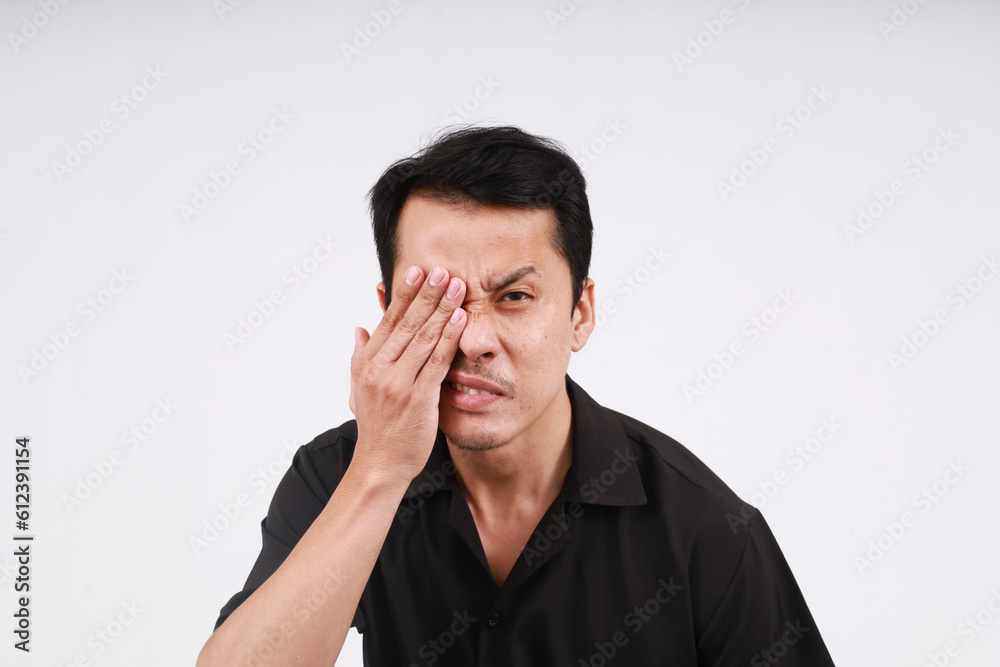 Asian man wearing black shirt put your hands around your eyes painful expression Asian man wearing black shirt put your hands around your eyes painful expression