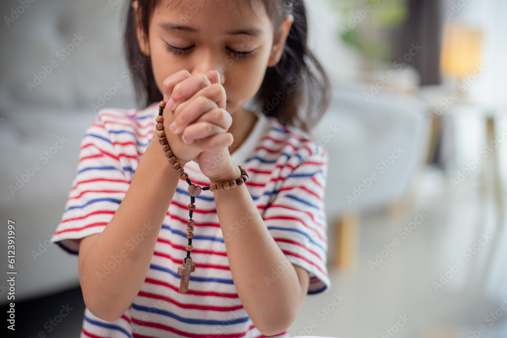 Christian concept. Little Asian girl praying withholding the cross. Concepts of hope, faith, Christianity, religion, Christian concept. Little Asian girl praying withholding the cross. Concepts of hope, faith, Christianity, religion,