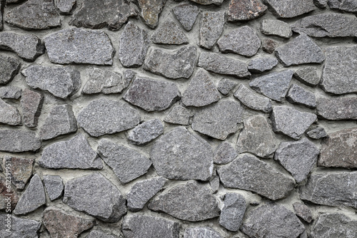 Gray stone wall texture. Wide panoramic rock pattern. Natural masonry surface, brick frame. Grey wall background grunge texture. decorative uneven cracked real stone structure. Design element.