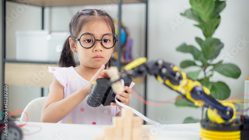 STEM education concept. Asian students learn at home by coding robot arms in STEM, mathematics engineering science technology computer code in robotics for kids' concepts