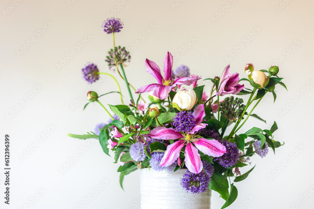 Flowers from a home garden in a vase on a white background.
