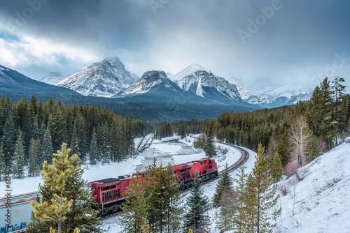 Morants curve with canadian train passing the valley in winter at Banff national park