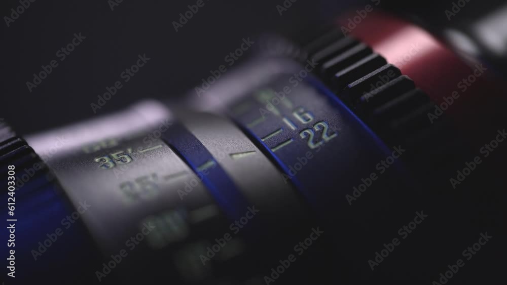 camera lens close-up of the dial with blue light in the background and blurred lens background, anamorphic lens, macro photography, video art