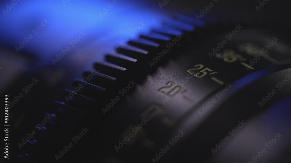 camera lens close-up of the dial with blue light in the background and blurred lens background, anamorphic lens, macro photography, video art
