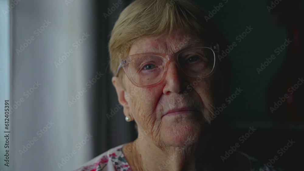 Close-Up of Elderly Woman with Serious Expression Looking at Camera, Dramatic Lighting Accentuating Experience and Old Age Close-Up of Elderly Woman with Serious Expression Looking at Camera, Dramatic Lighting Accentuating Experience and Old Age