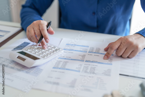 Woman calculating monthly expenses  taxes and interest calculate at home.