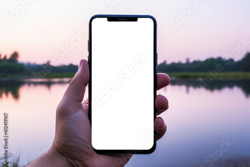 Hand holding smartphone with blank transparent screen  on a lake background, Smartphone mockup, generative AI. 