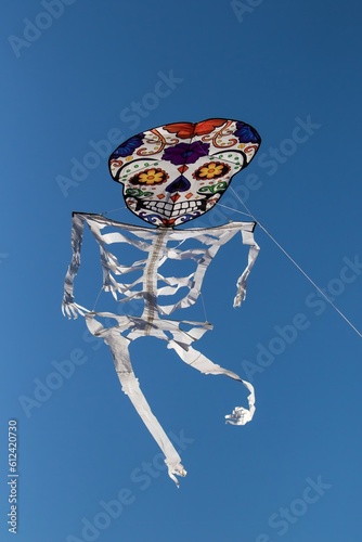 A novelty styalized skeliton kite in the air at a kite festival at Lincoln City Oregon photo