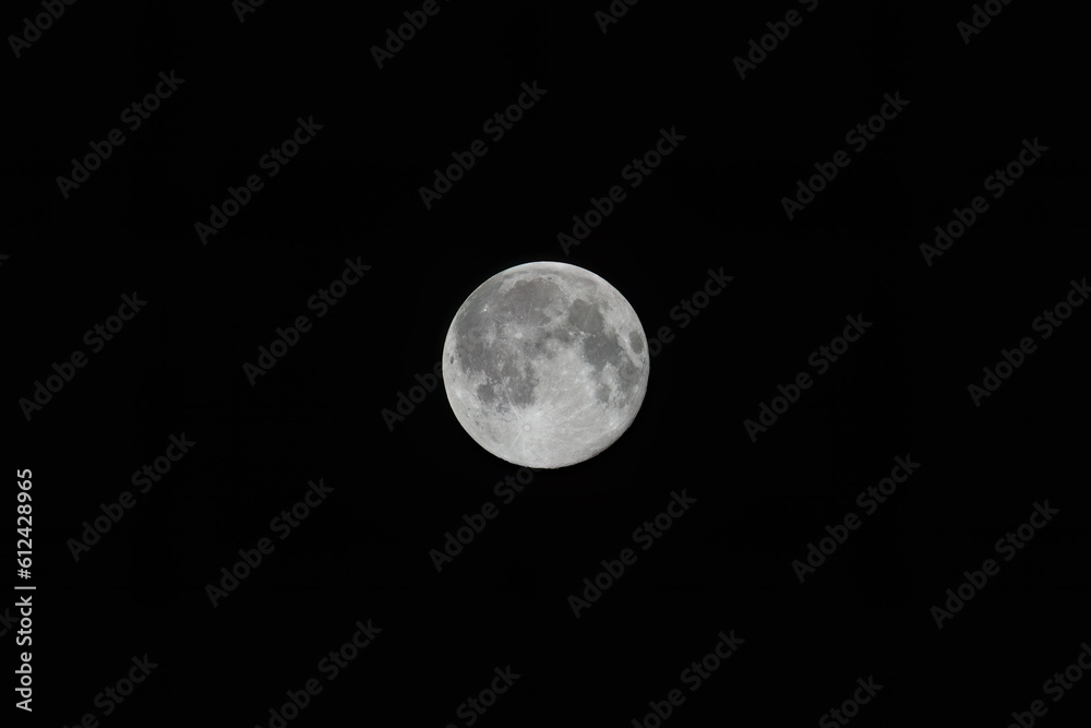 Obraz premium Full moon at night with black background.