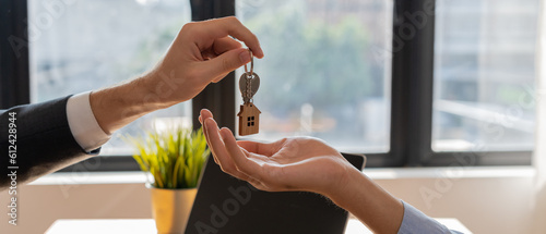 lease, rental and selling home. Real estate agent manager smile holding key for new owner.  rent house, Sales, loan credit financial, insurance, Seller, dealer, installment,  buy, sell, move in