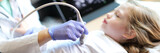Doctor making diagnostic examination of internal organs in children using ultrasound machine.