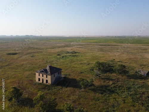 Aerial shot of the abandoned farmhouse in Prairies in Saskatchewan, Canada