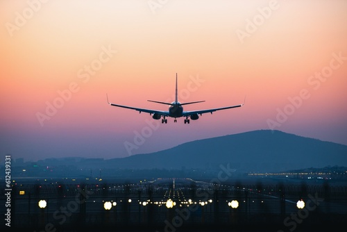 Airplane departing from airport during sunset