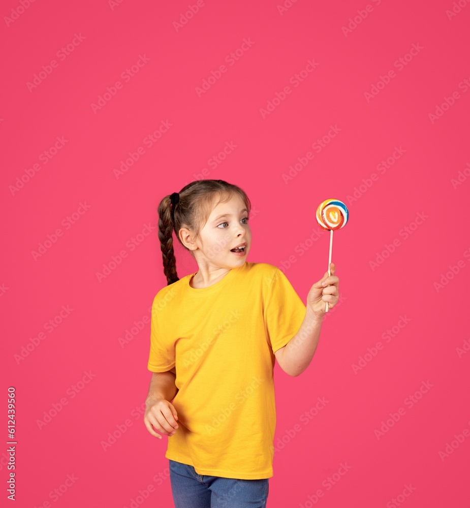 Sweet Treat. Excited Cute Little Girl Holding Colorful Candy In Hand Sweet Treat. Excited Cute Little Girl Holding Colorful Candy In Hand
