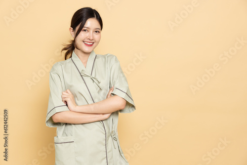 Young Asian woman wearing patient outfits isolated on brown background, Personal accident concept