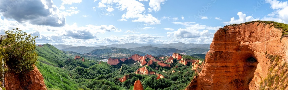 Panoramic scene of Las Medulas rocky cliffs with green hills in Spain